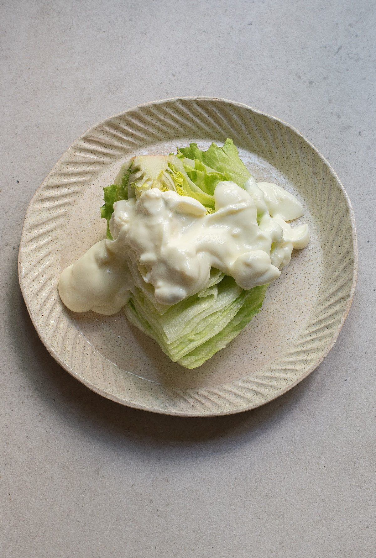 one wedge of iceberg topped with blue cheese dressing