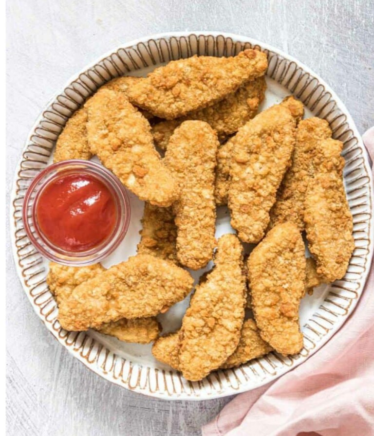 Frozen Chicken Tenders In Air Fryer in a white circle platter served with ketchup.