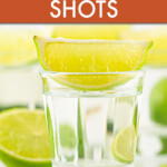 Close up of a shot glass with Kamikaze and a lime