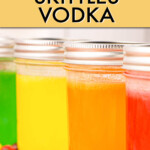 A row of jars of multicolored skittles vodka.