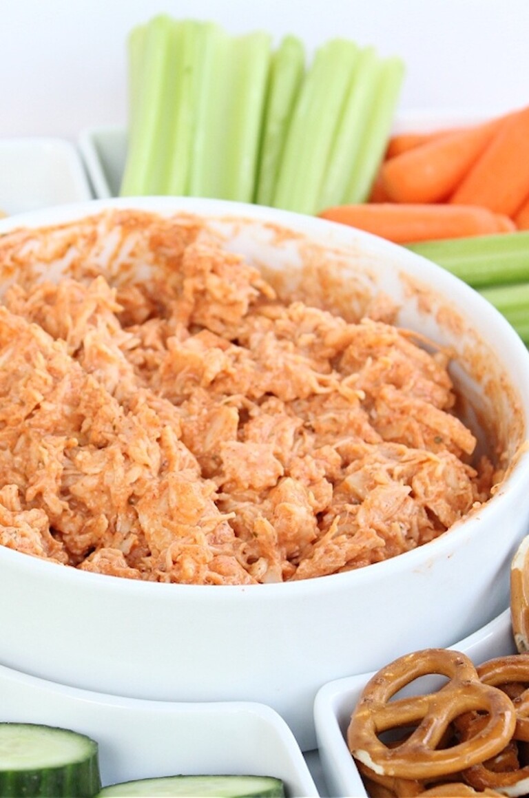 zero point weight watchers buffalo chicken dip in a white bowl with pretzels and celery sticks