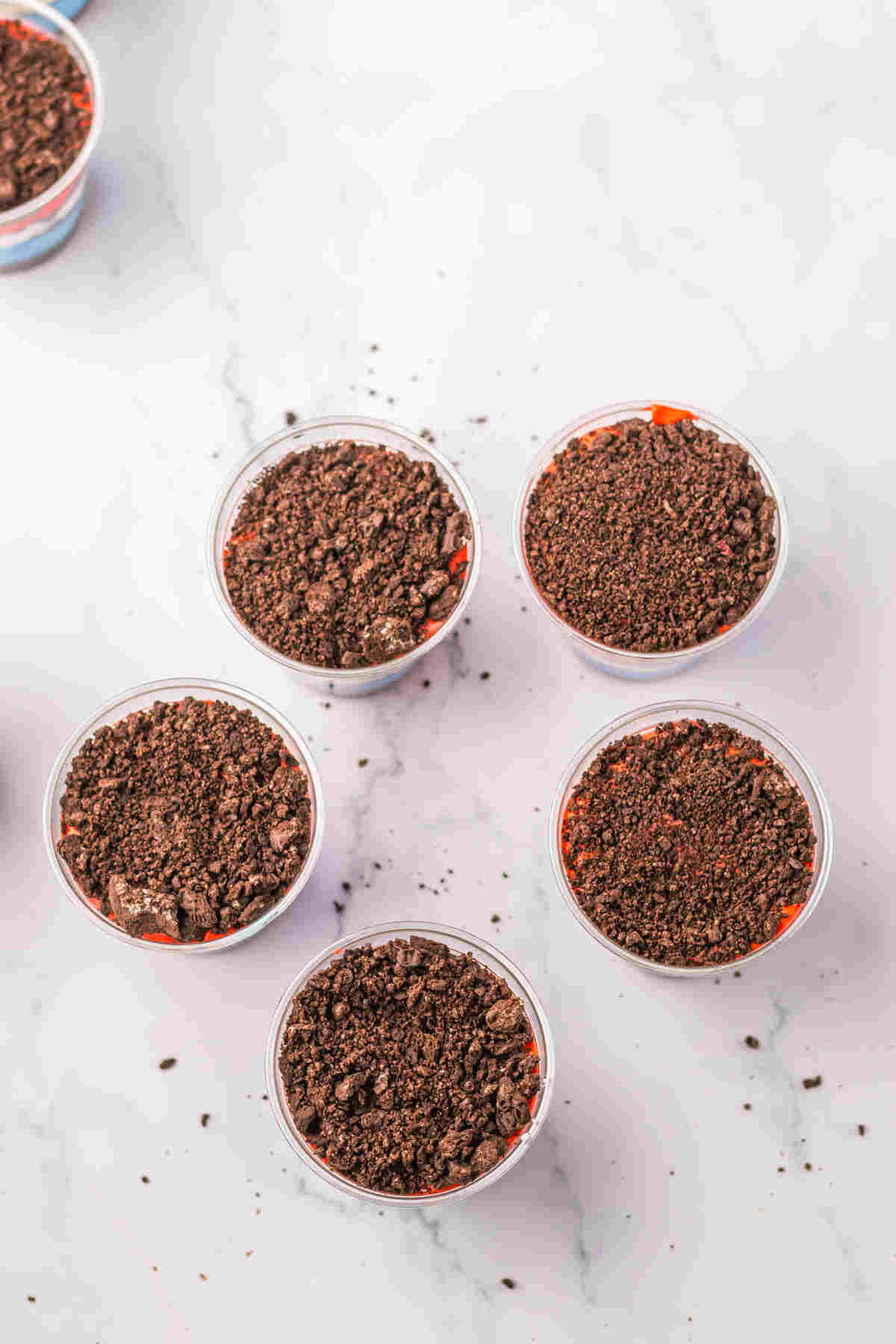 the individual dirt cup servings topped with the final layer of cookie crumbles.