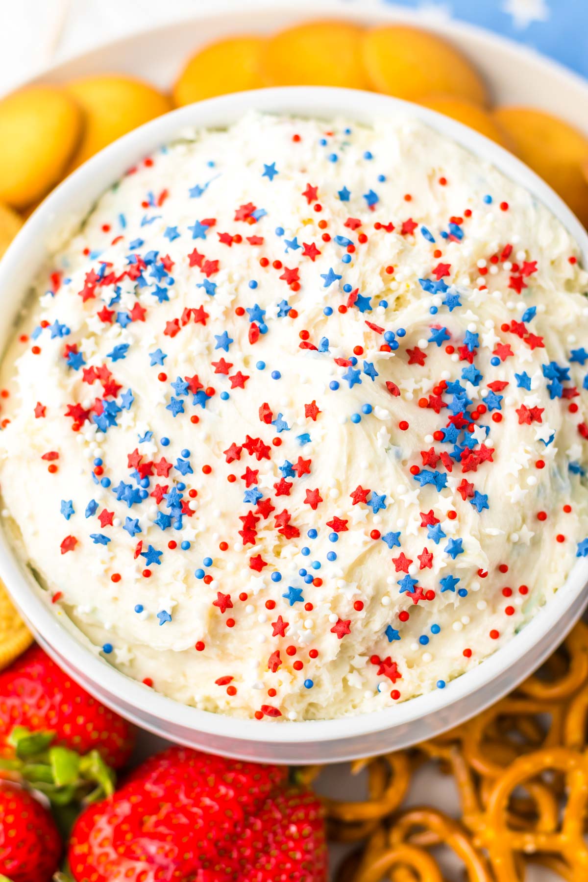 close up view of the completed funfetti cake batter dip served in a white bowl.