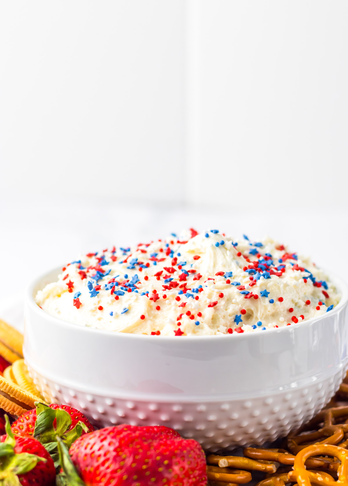 the finished cake dip in a white serving bowl.
