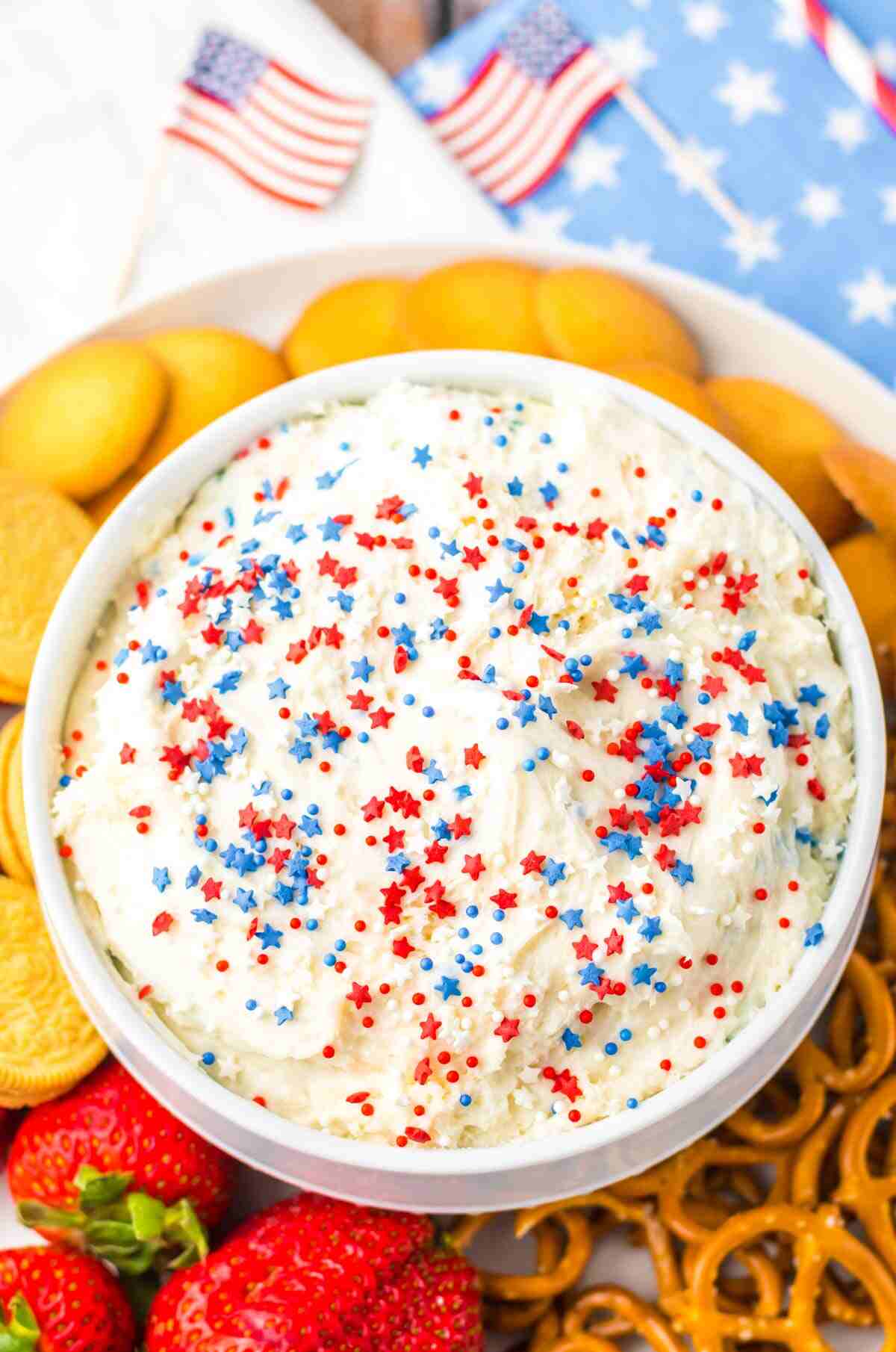 the completed cake batter dip recipe topped with sprinkles and served with a variety of dippers.