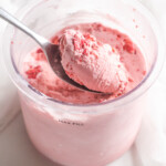 one spoonful of the completed Ninja Creami Strawberry Ice Cream being scooped out of the pint container.
