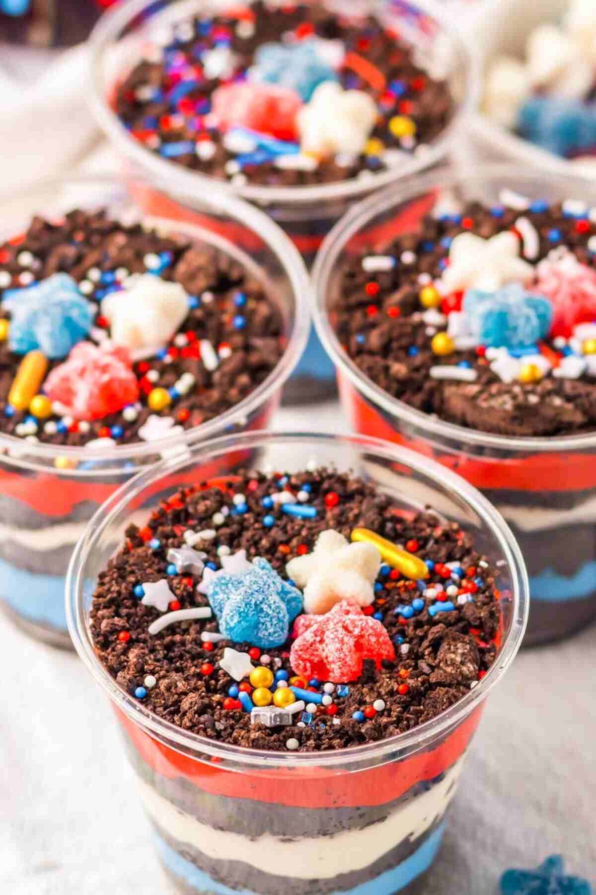 the completed dirt cups decorated with sprinkles and gummy stars.