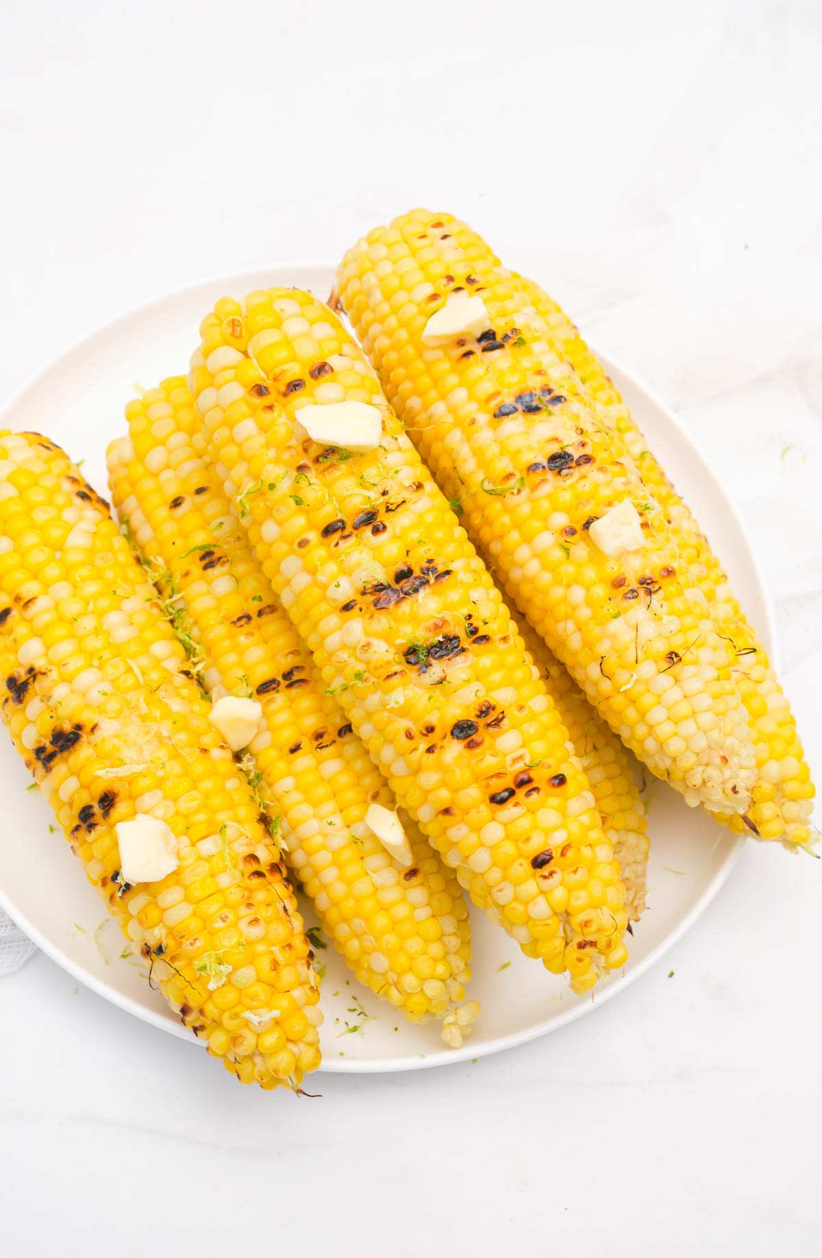 the finished corn seasoned with butter and fresh herbs.
