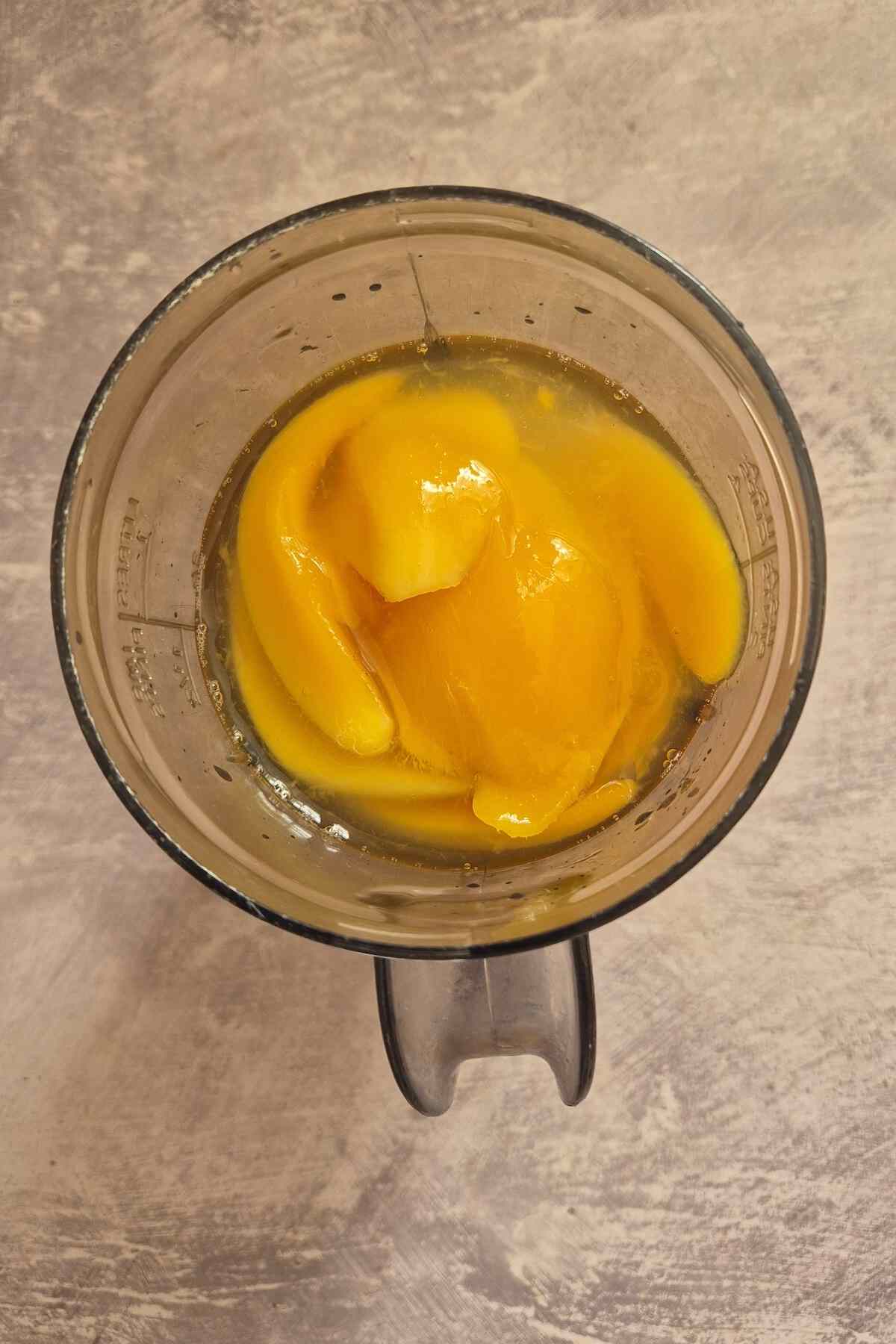 the mango sorbet ingredients inside a blender.