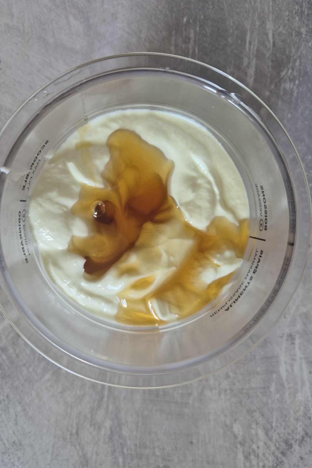 the ingredients for frozen yogurt inside the Ninja Creami pint container.