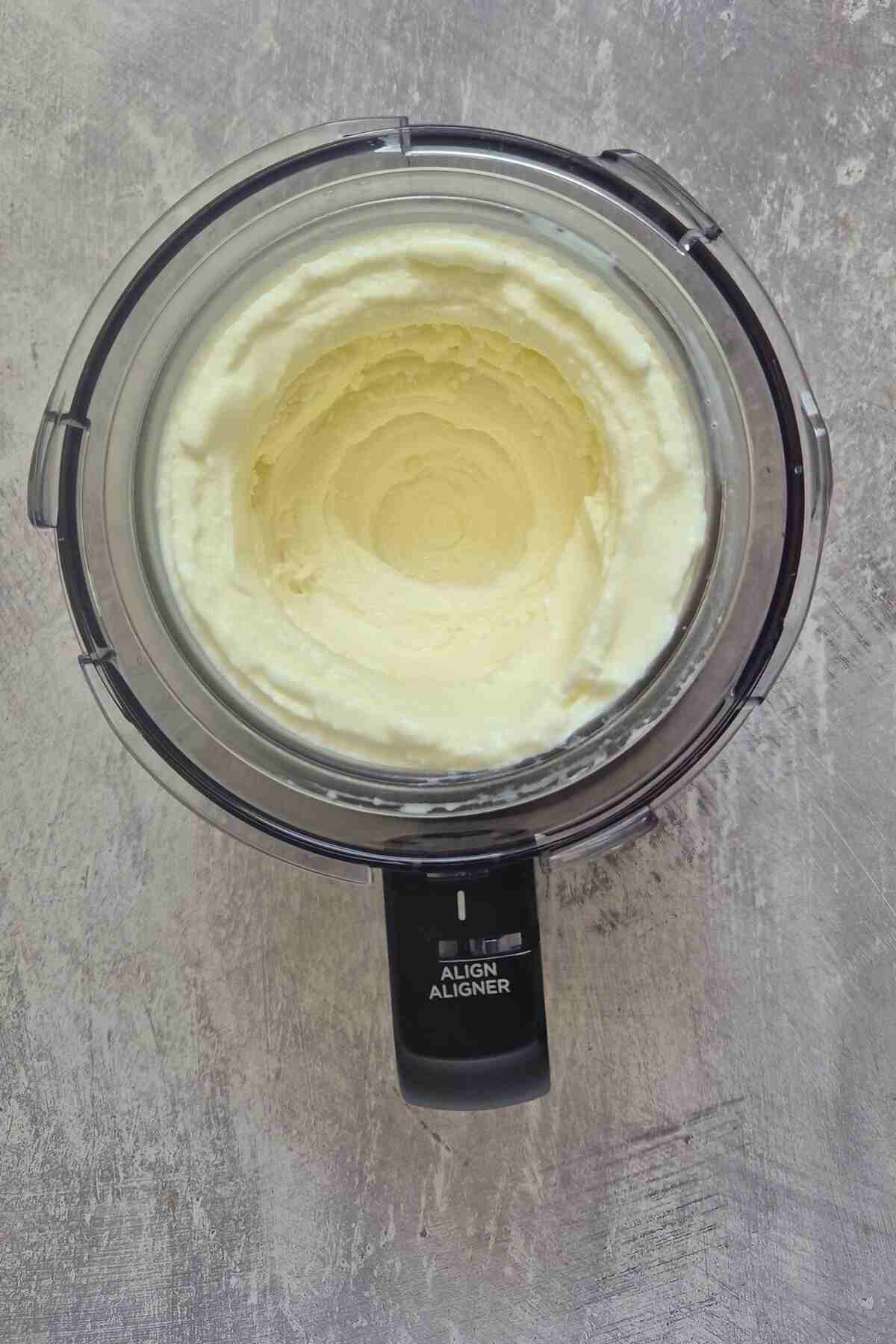 the processed frozen yogurt inside the Ninja Creami bowl.