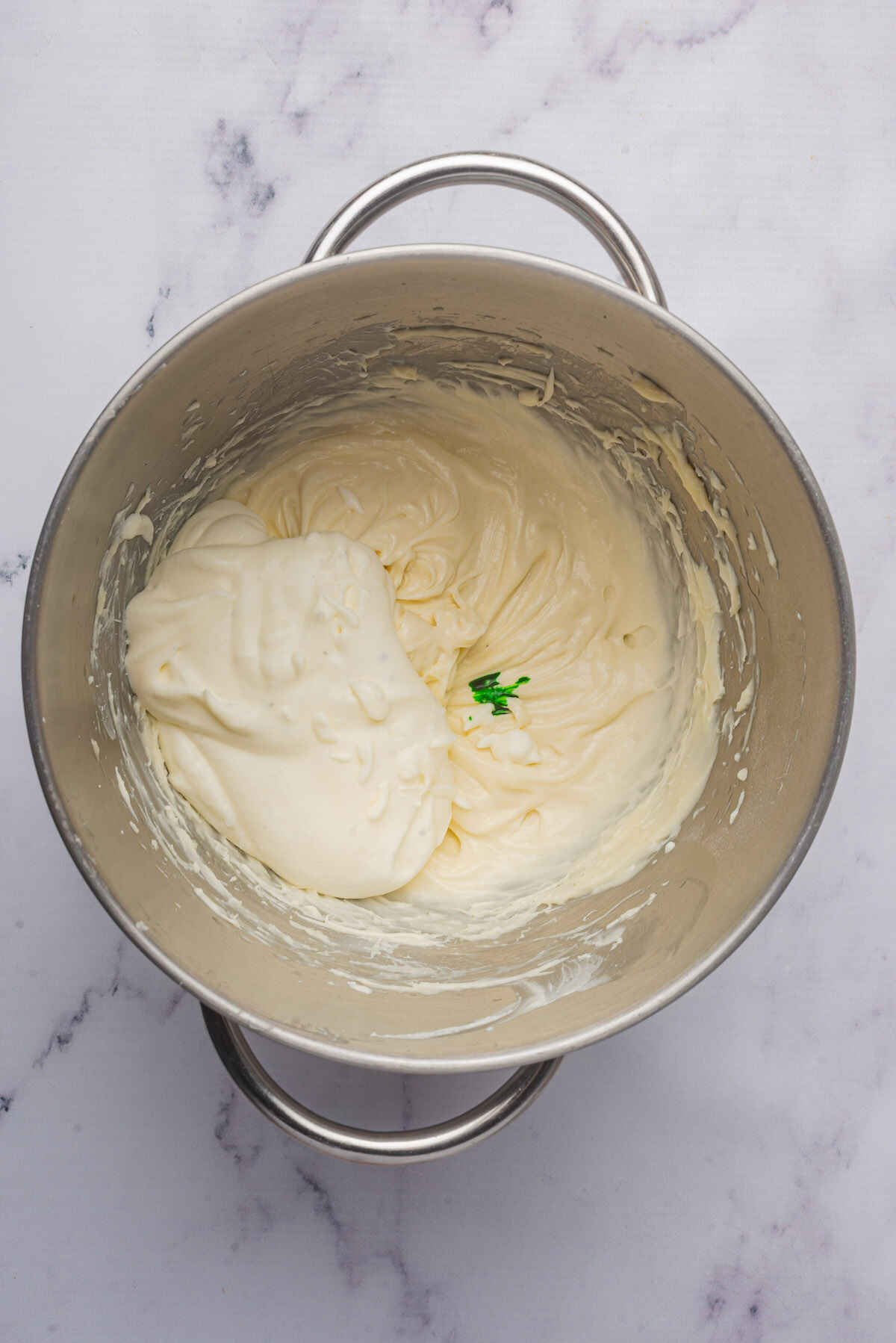 Cool whip and green food coloring added to the dip mixture.