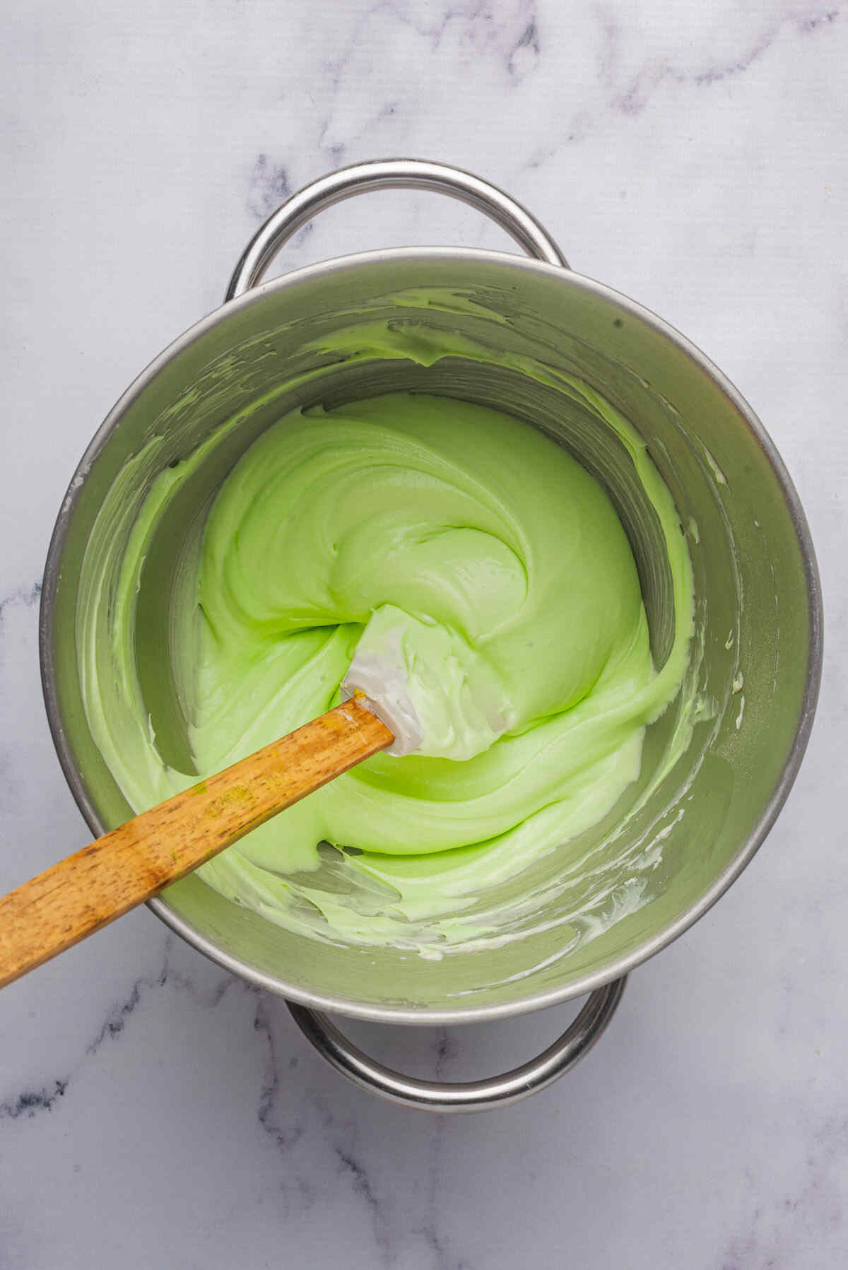 a spatular inside the green dip mixture.