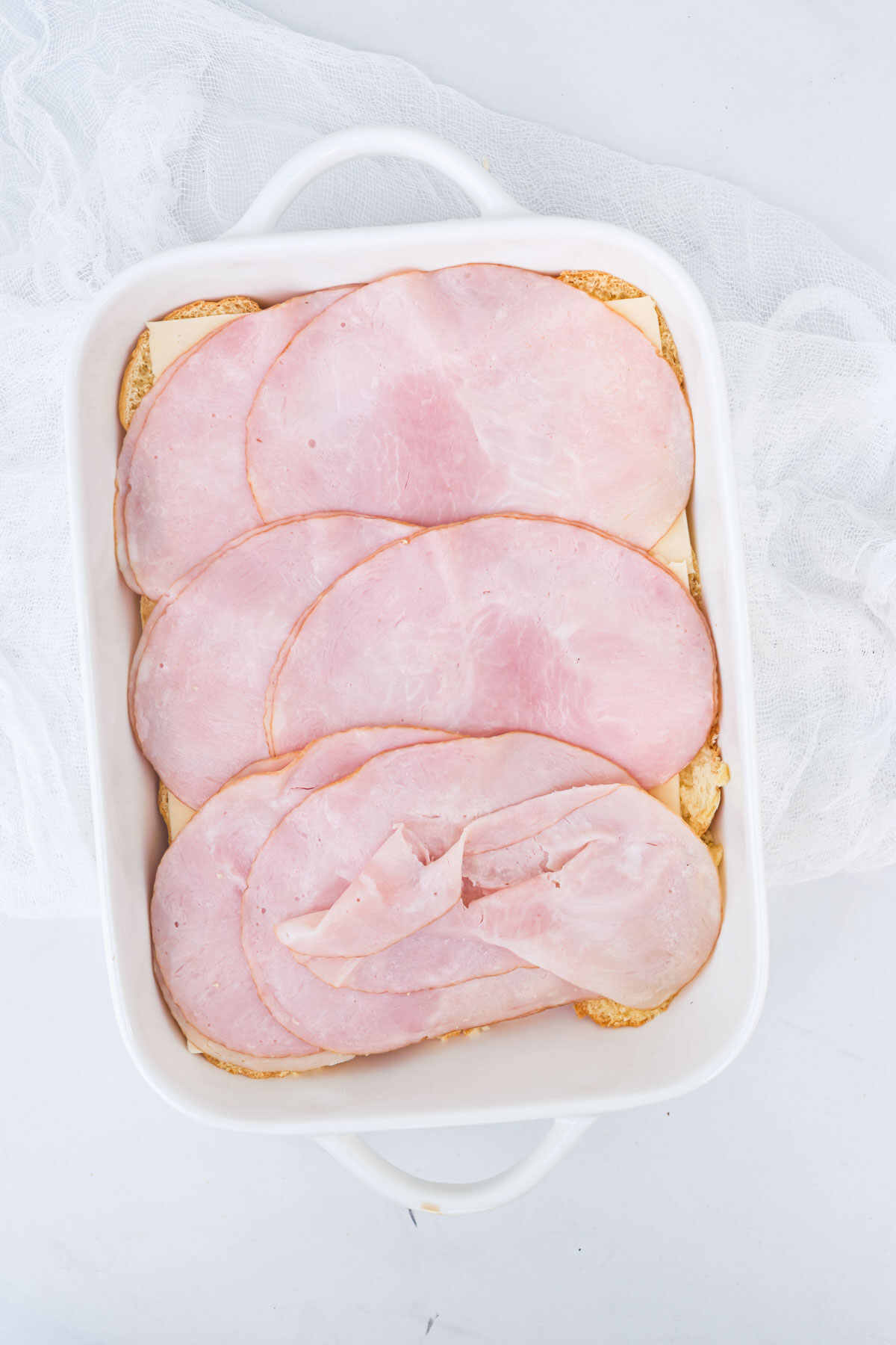 the ham and cheese layered onto the Hawaiian rolls.