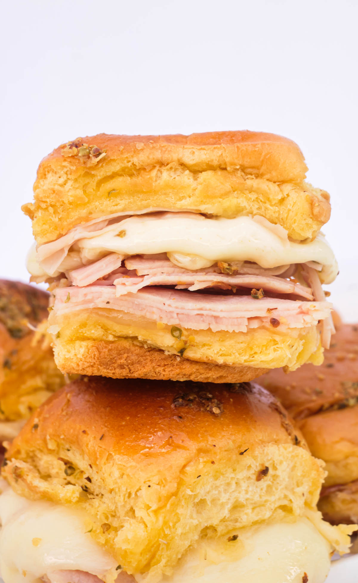 the ham sliders stacked on a place and ready to serve.