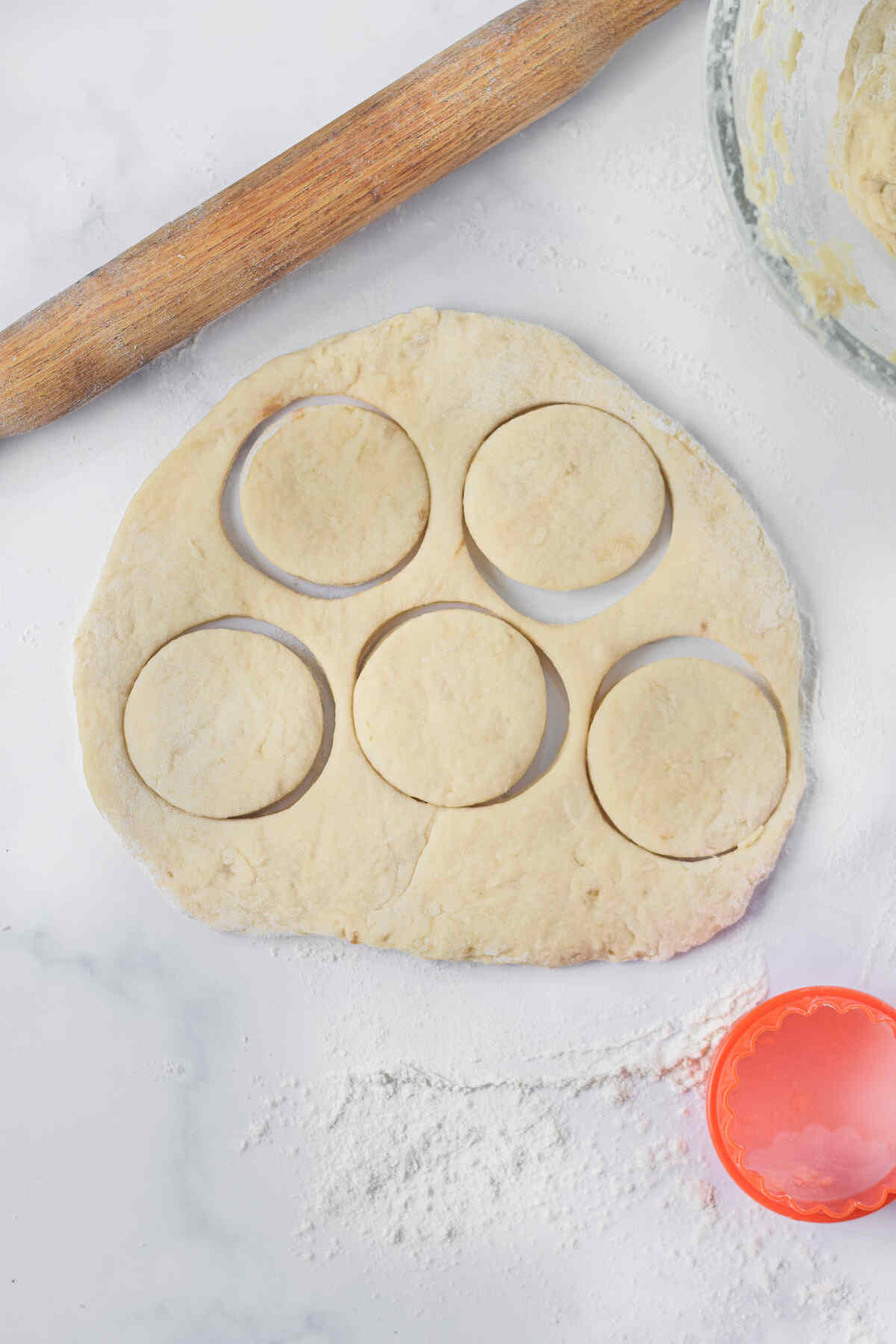 the donut dough being cut into circles.