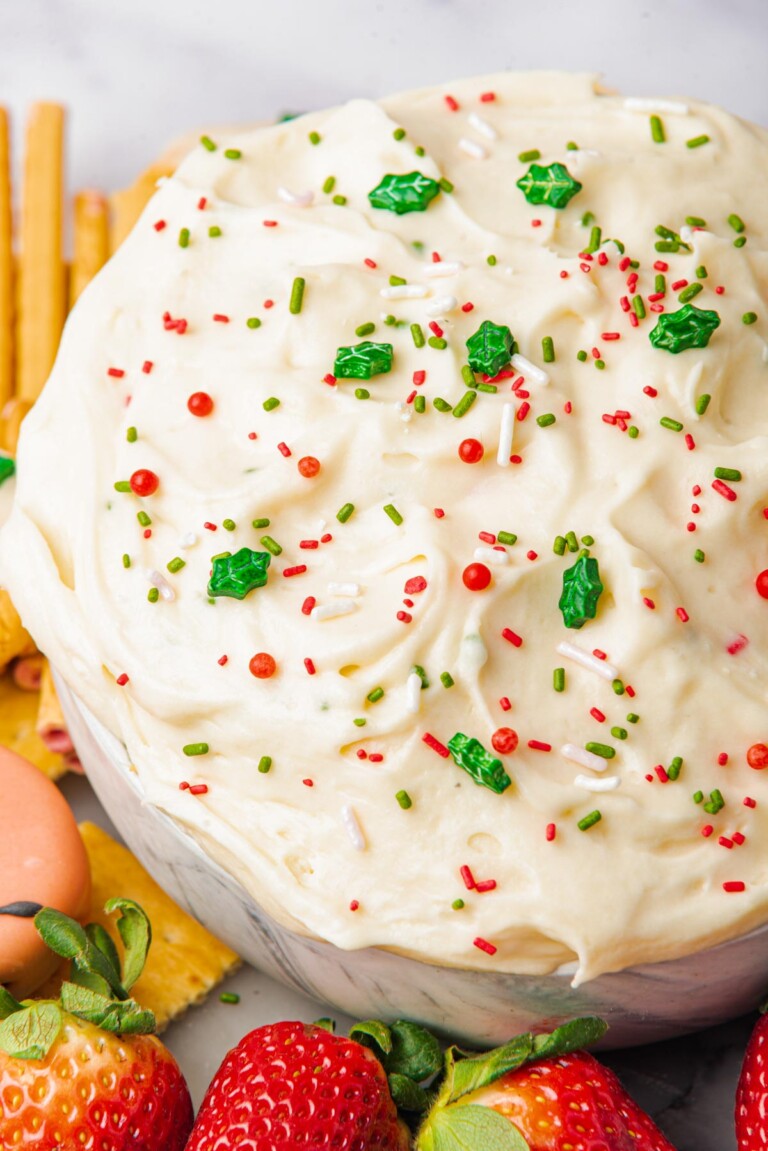 the finished Christmas Cookie Dip recipe served with berries and cookie dippers.
