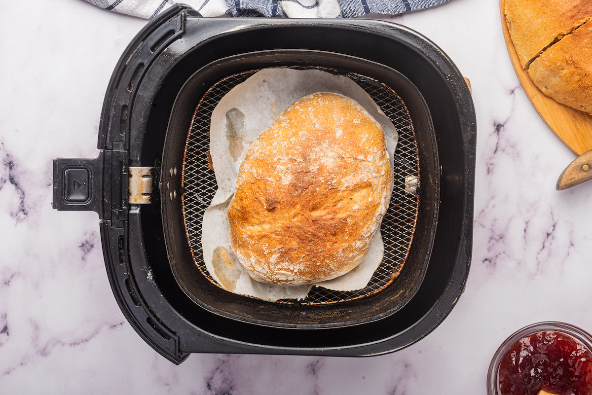 top down view of the bread loaf inside the air fryer basket.