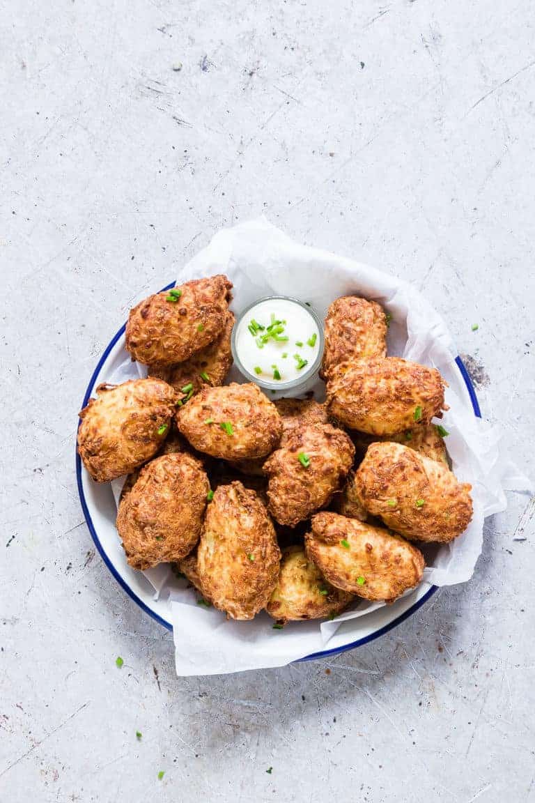 a dish filled with Air Fryer Tater Tots and a small bowl of vegan ranch dressing