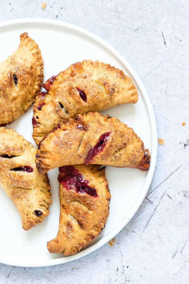 close up of a plate filled with air fryer blueberry hand pies