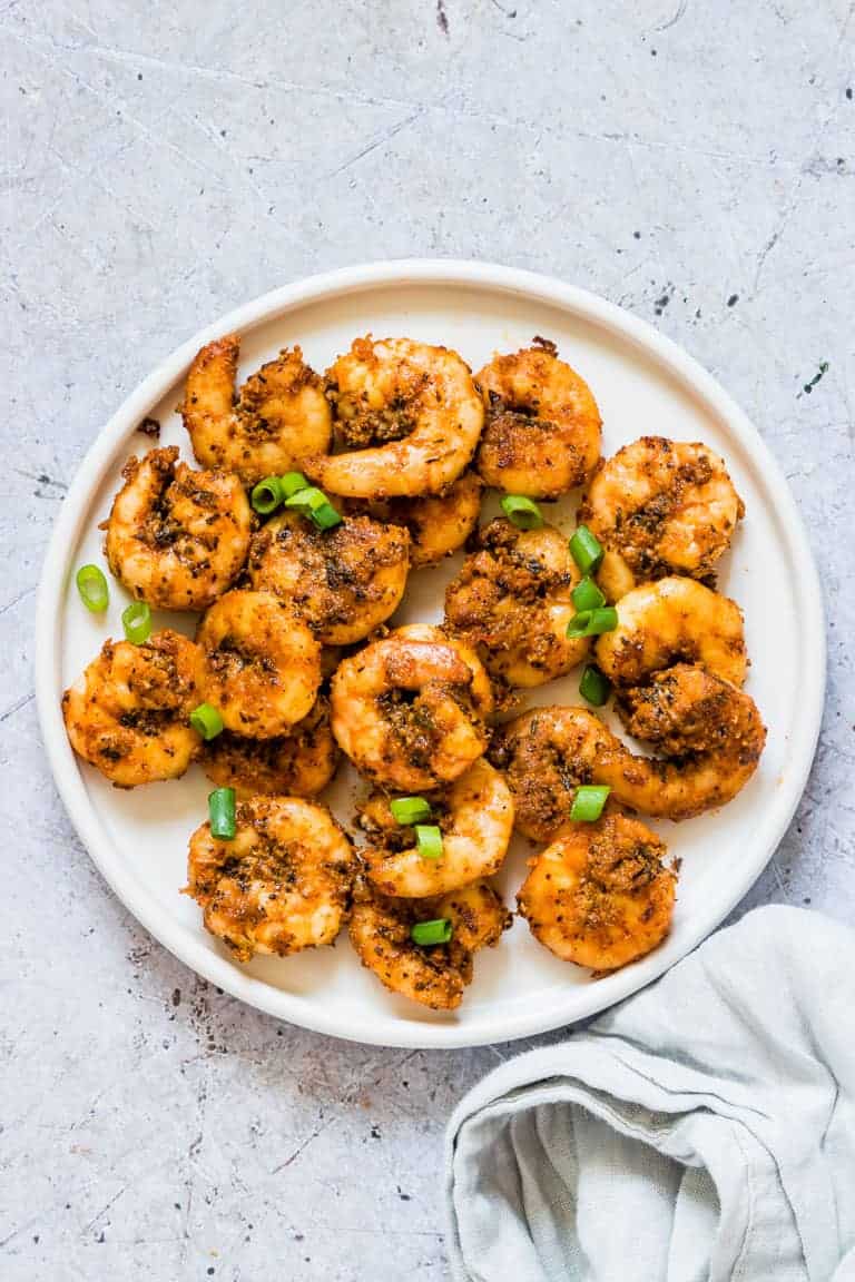 The completed Cajun Shrimp Recipe served on a white plate with cloth napkin