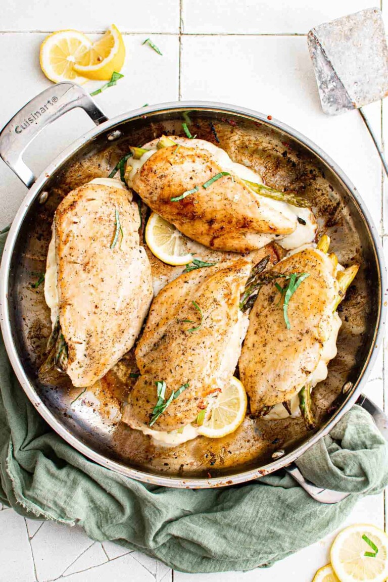 Asparagus stuffed chicken breast in a skillet.