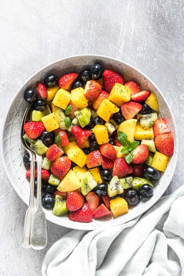 Fruit salad in a white bowl.