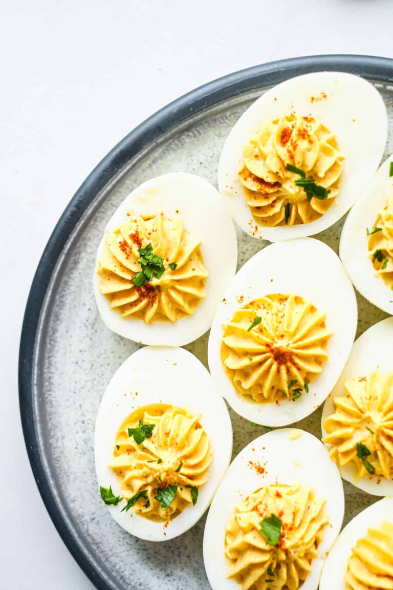 Spicy deviled eggs on a white plate.