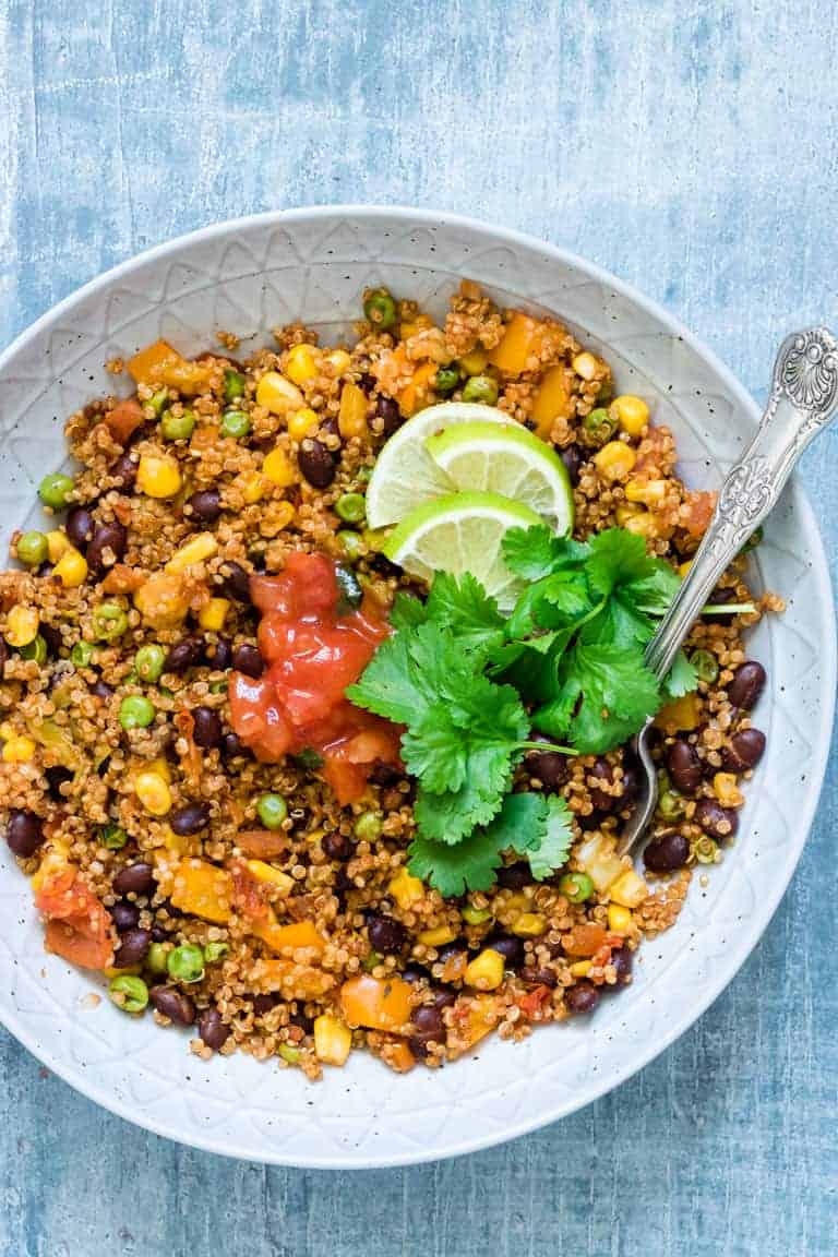 dump and start instant pot mexican quinoa served with cilantro and lime wedges