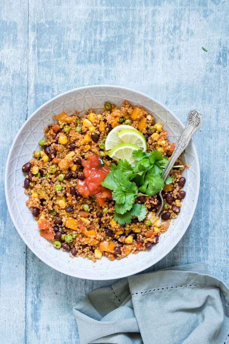 a bowl of Dump and Start Instant Pot Mexican Quinoa served with a spoon and cloth napkin