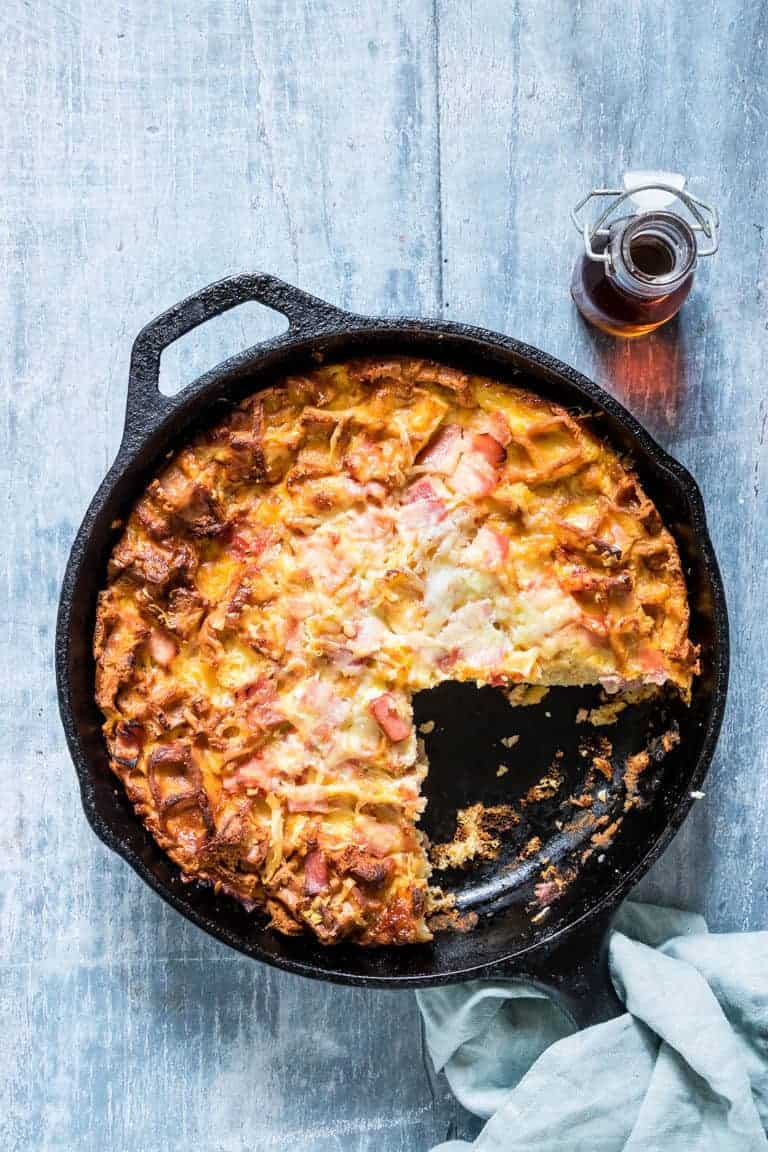 Cheesy Waffle and Ham Breakfast Casserole in the skillet with one serving removed