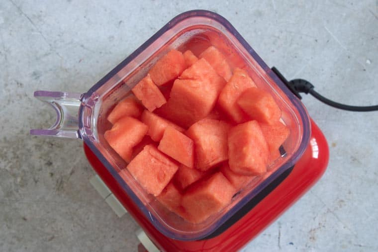top down view of watermelon chunks inside blender