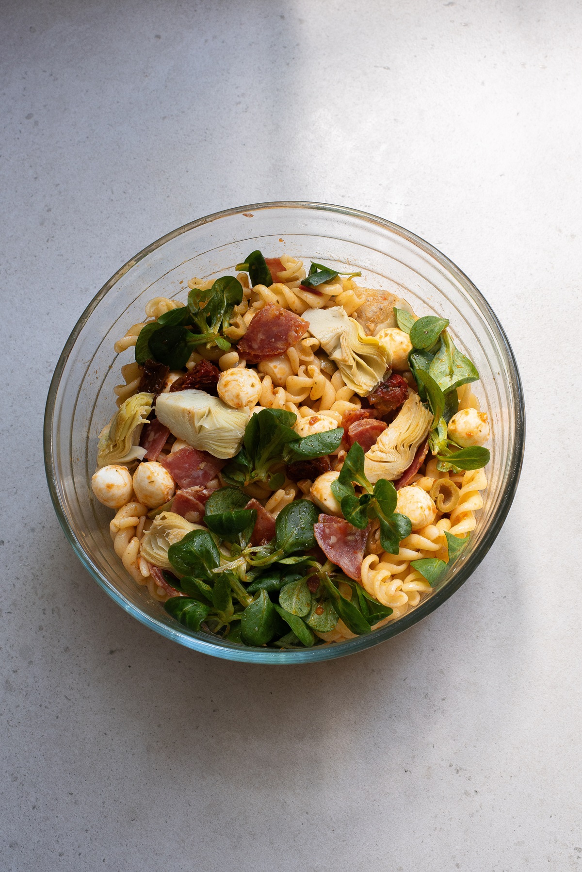Pasta salad with dressing on it.