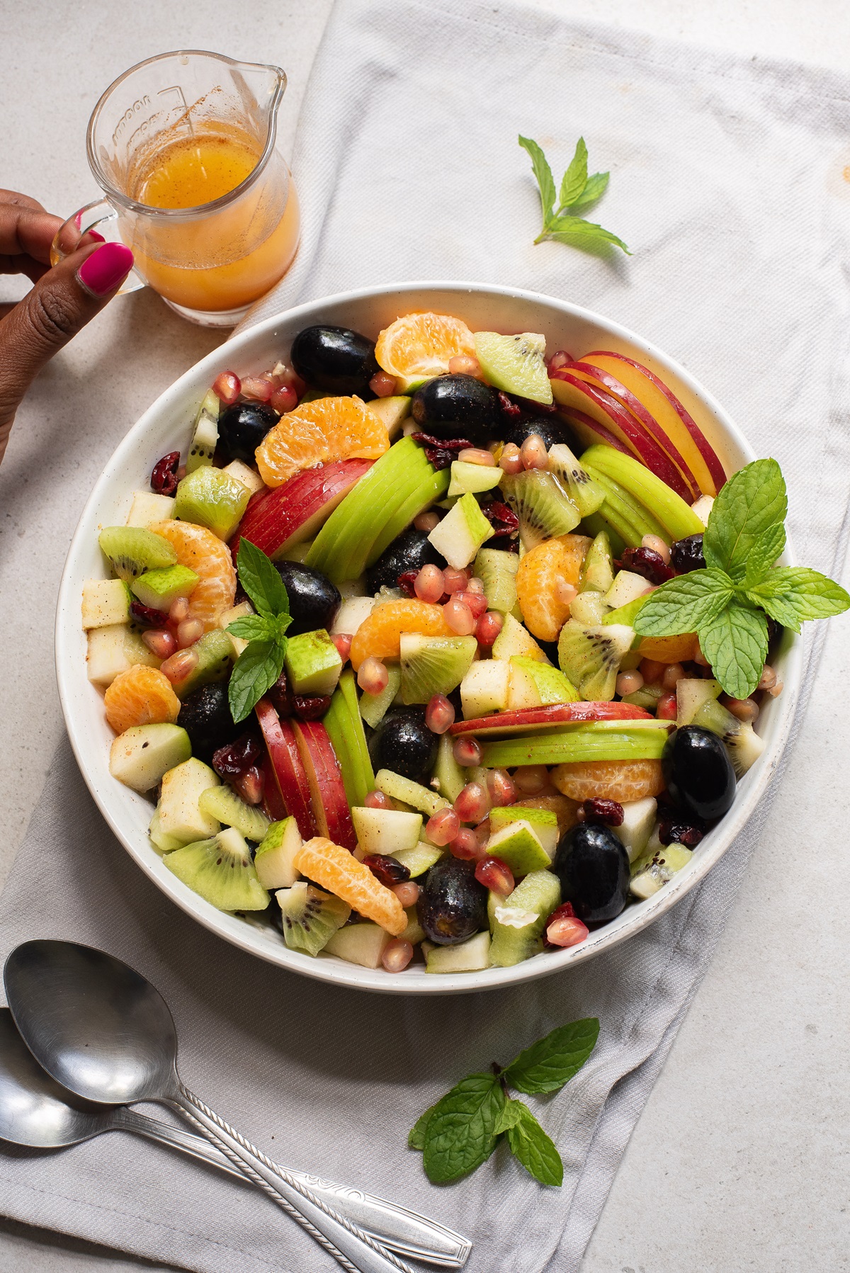 Bowl of fruit with dressing.