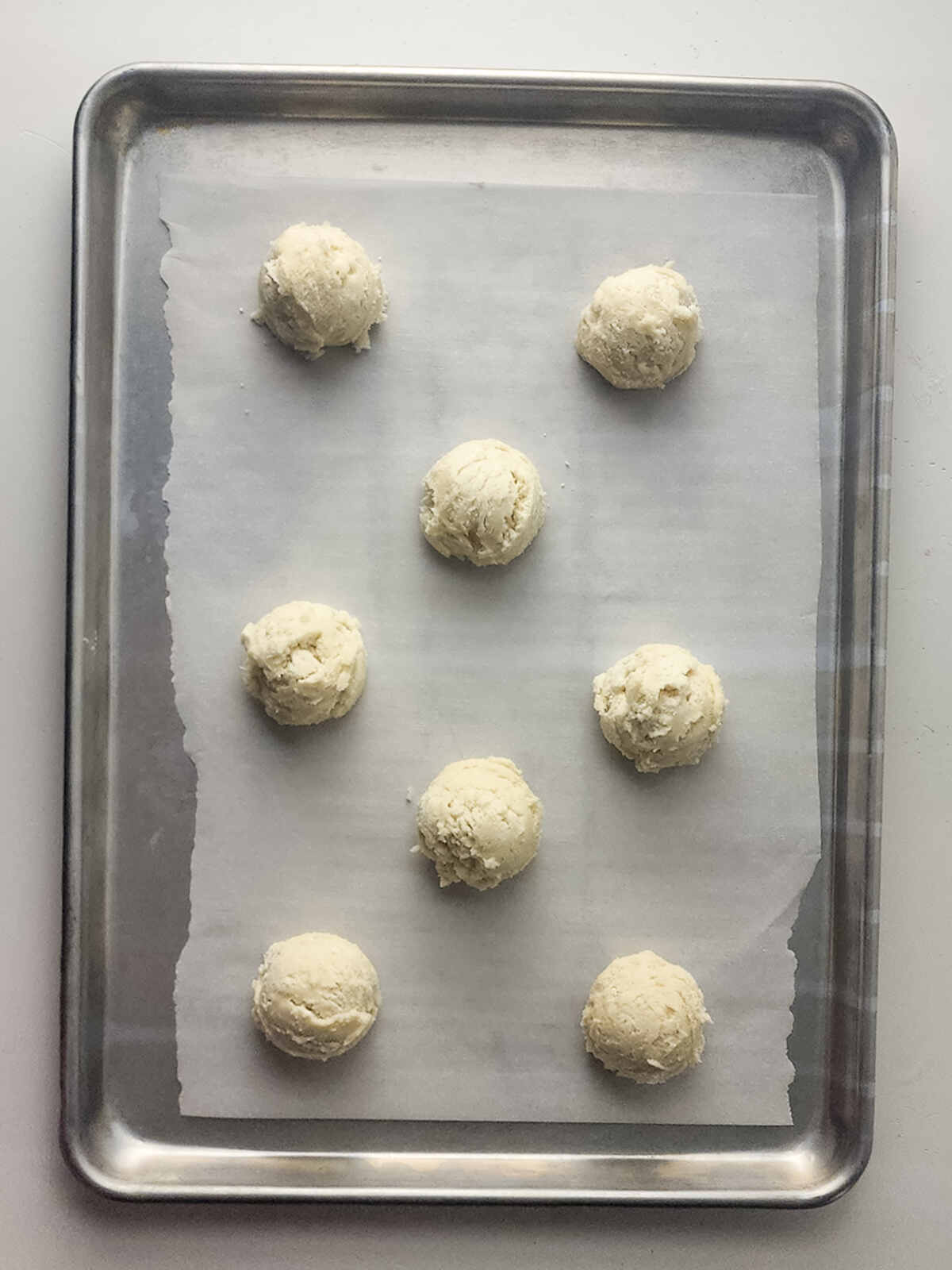 Raw cookies on a baking sheet.