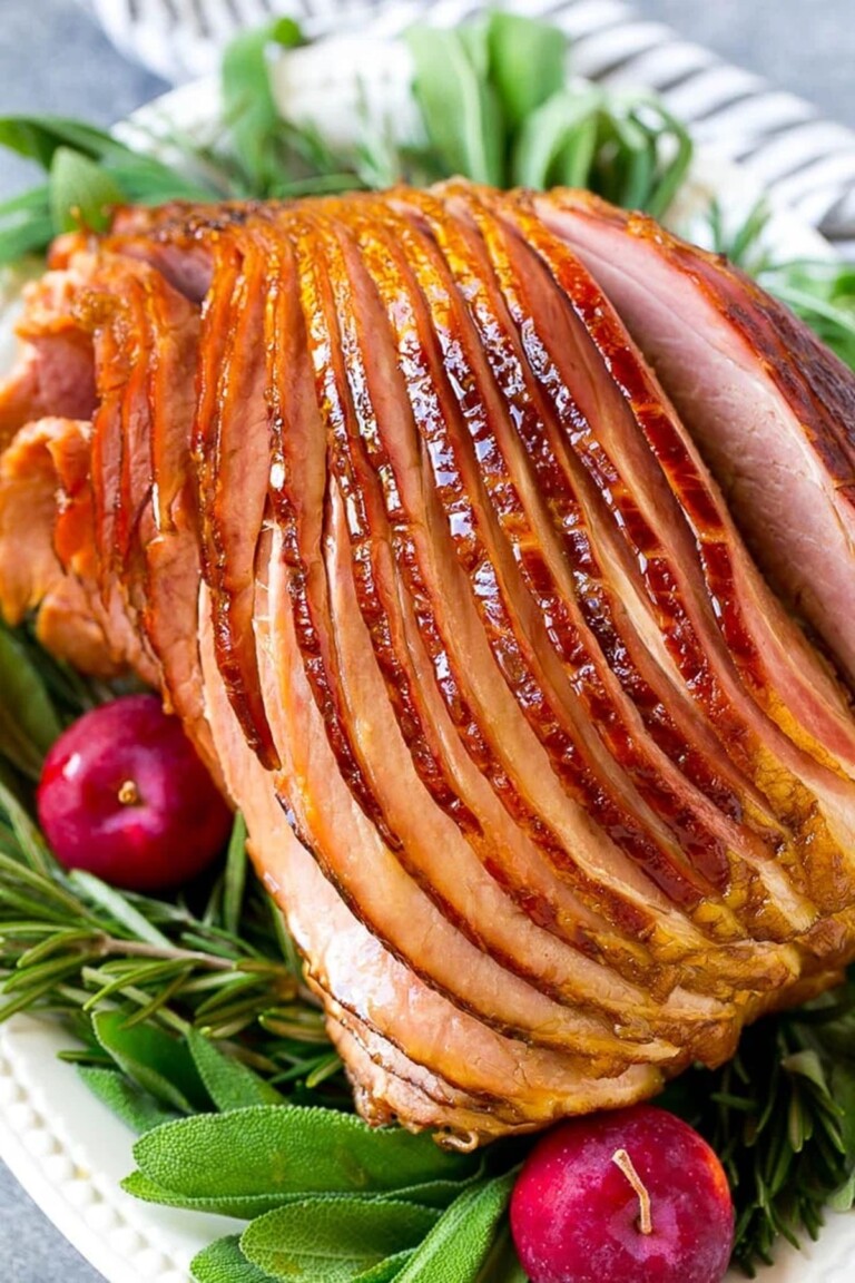 Close up view of crock pot ham with garnishes.