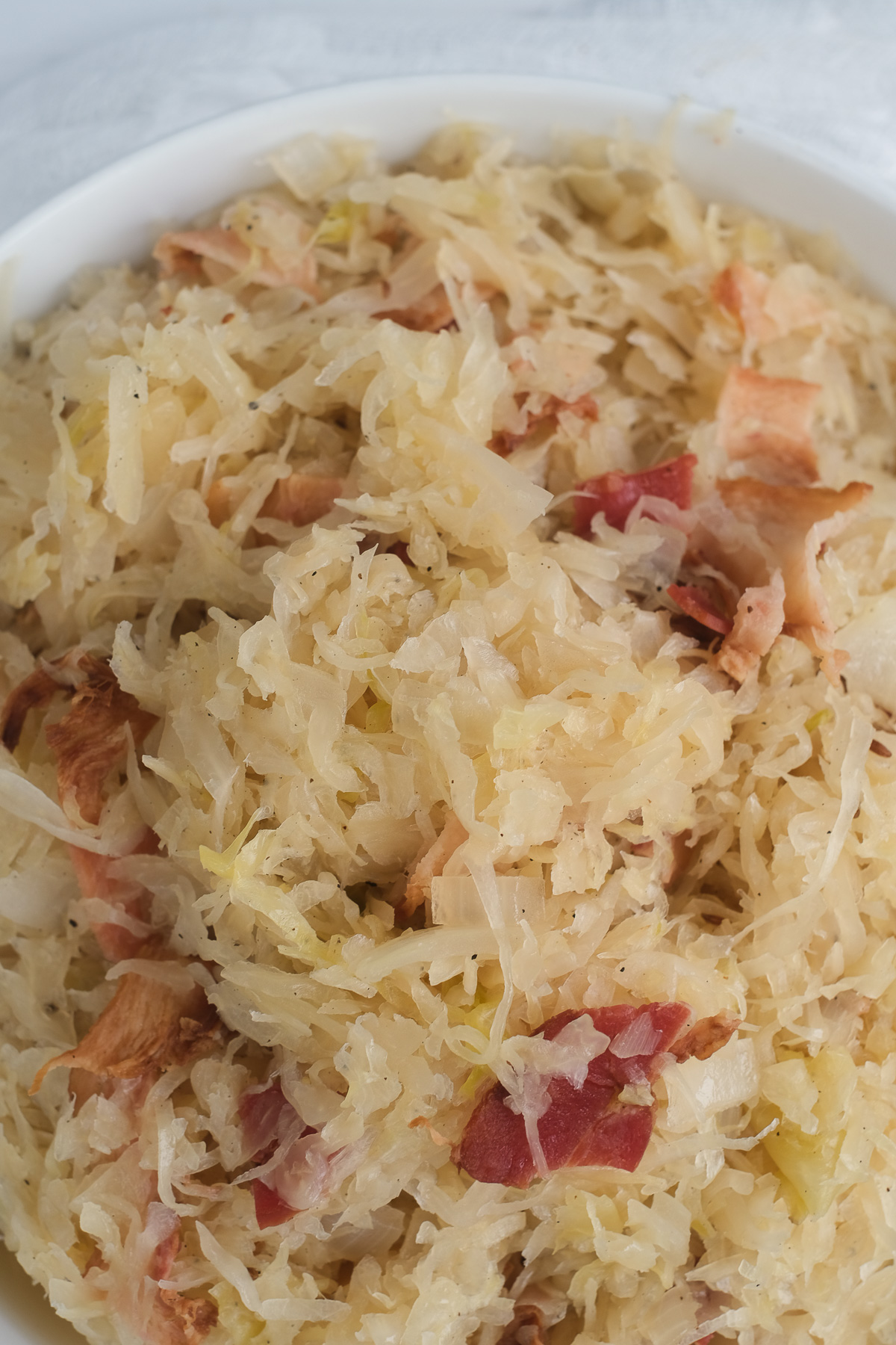 Close up view of sauerkraut with bacon bits.