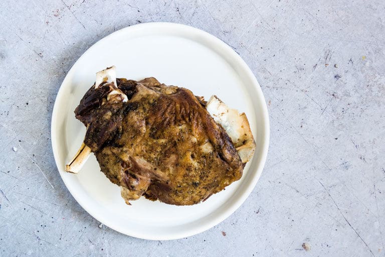 Cooked Instant Pot Lamb on a white plate and ready to be served