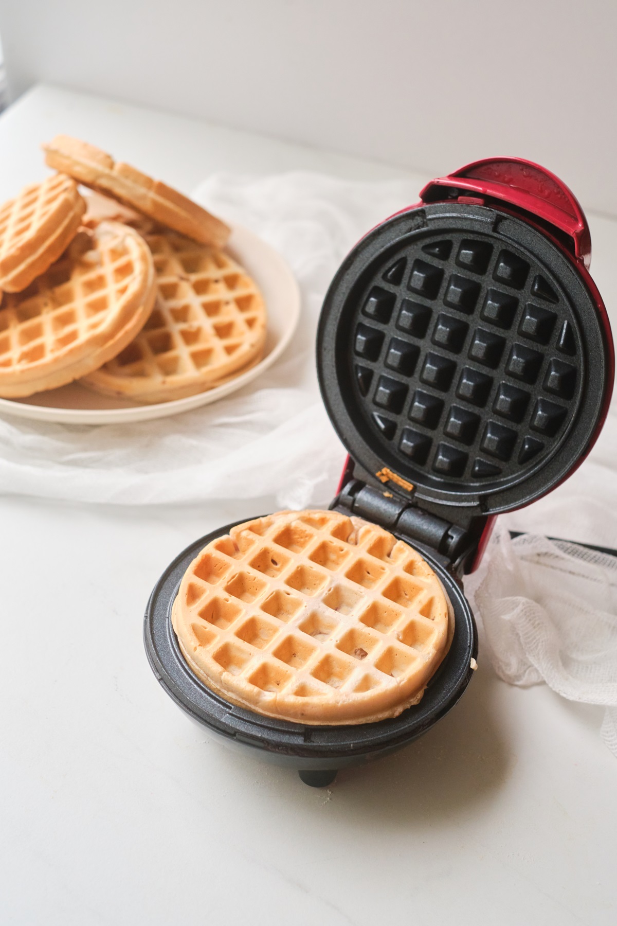 A waffle being made in a waffle iron.