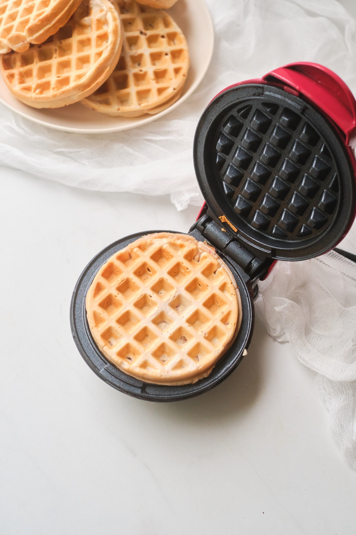 A waffle being made in a mini waffle iron.