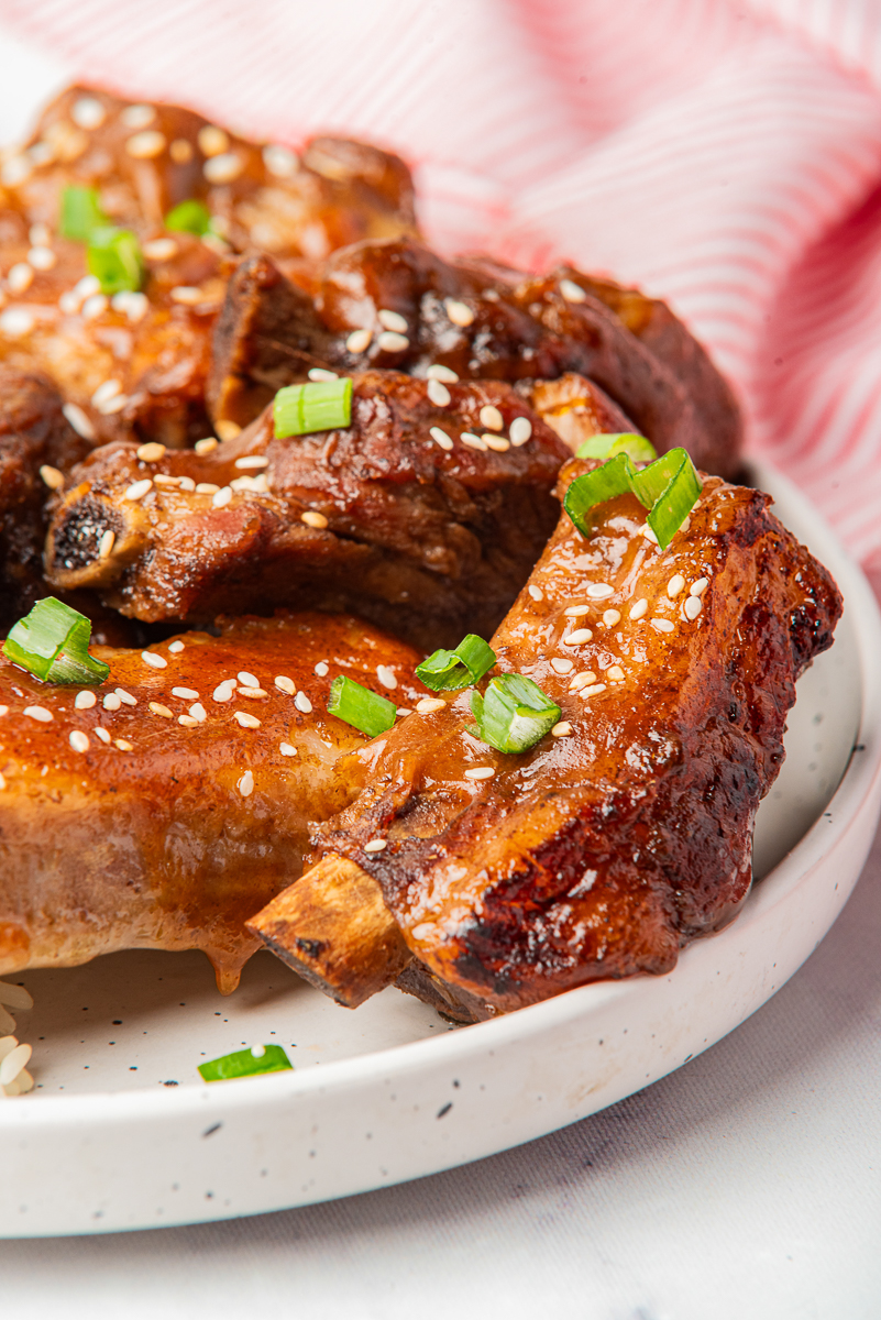 Chinese style crockpot ribs glazed with honey soy sauce and topped with sesame seeds