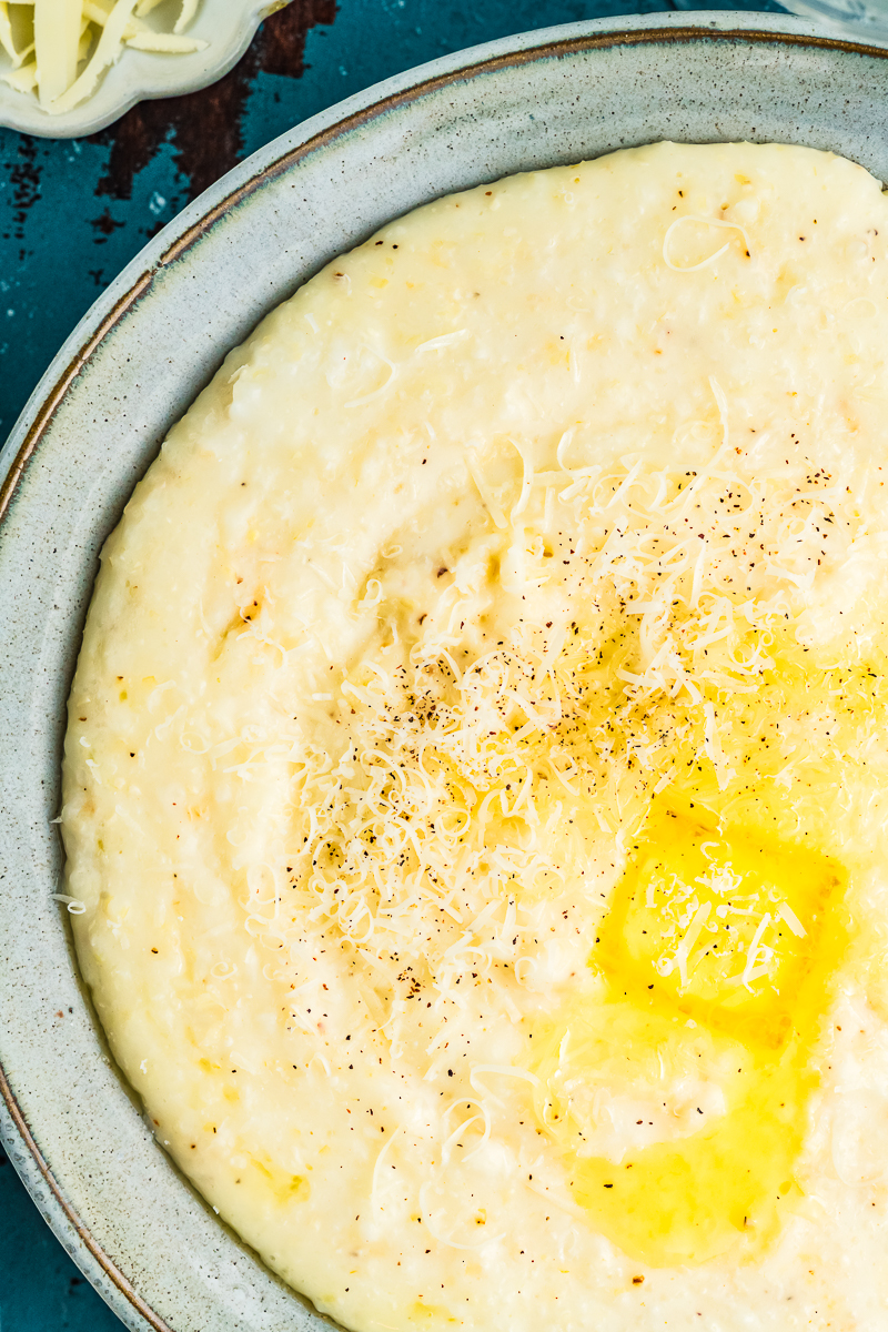 Close up of creamy grits in a green bowl.