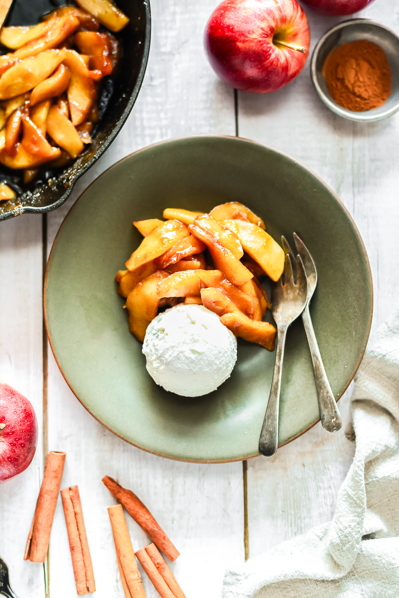 Fried apples in a serving plate with ice cream.